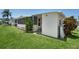 Well-maintained single-story home with a lush lawn and an inviting screened porch area at 307 White Oak Way, Sarasota, FL 34237