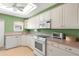 Functional kitchen featuring white appliances, ample counter space, and light wood-look flooring at 307 White Oak Way, Sarasota, FL 34237