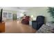 Comfortable living room with laminate flooring, large windows, and neutral paint, open to the dining area at 307 White Oak Way, Sarasota, FL 34237