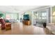 Cozy living room with sliding doors to the sunroom, wood flooring, and bright interior at 307 White Oak Way, Sarasota, FL 34237