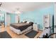 Bright main bedroom featuring ceiling fan, wood-look flooring, and ample closet space at 307 White Oak Way, Sarasota, FL 34237