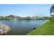 Scenic pond view with a fountain feature, surrounded by lush greenery and well-maintained properties at 307 White Oak Way, Sarasota, FL 34237