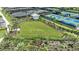 Aerial view of recreational area with tennis courts and open lawn space at 3221 Vicenza Ct, Bradenton, FL 34211