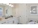 Bright bathroom with marble counters, bronze fixtures, framed art and tub at 3221 Vicenza Ct, Bradenton, FL 34211
