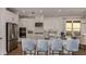 Modern kitchen featuring white cabinetry, stainless steel appliances, and a large island with seating at 3221 Vicenza Ct, Bradenton, FL 34211