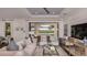Bright and inviting living room with elegant furniture, stylish decor, and a view of the outdoor space at 3221 Vicenza Ct, Bradenton, FL 34211