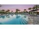 Large pool with lounge chairs and umbrellas offer a relaxing experience at 3221 Vicenza Ct, Bradenton, FL 34211