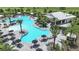 An aerial view of a sparkling pool with lounge chairs and umbrellas at 3221 Vicenza Ct, Bradenton, FL 34211