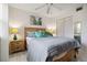 Cozy bedroom with a wood-framed bed, ceiling fan, and windows, creating a relaxing atmosphere at 3269 Beneva Rd # 103, Sarasota, FL 34232
