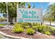 Entrance to Village Brooke Condominiums, featuring lush landscaping and well-maintained grounds, offering a welcoming view at 3269 Beneva Rd # 103, Sarasota, FL 34232