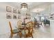 Cozy dining area with a glass table, seating for four, and a mirrored wall for an expanded feel at 3269 Beneva Rd # 103, Sarasota, FL 34232