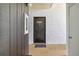 A condo entrance featuring textured walls, unit number, and a welcome mat inviting guests inside at 3269 Beneva Rd # 103, Sarasota, FL 34232