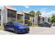 A condo building featuring a terracotta roof and balconies, complemented by tropical landscaping and a convenient parking area at 3269 Beneva Rd # 103, Sarasota, FL 34232