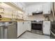 Bright kitchen featuring white cabinets, stainless steel appliances, and a stylish subway tile backsplash at 3269 Beneva Rd # 103, Sarasota, FL 34232