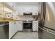 Well-lit kitchen showcasing white cabinetry, stainless steel appliances, and modern finishes at 3269 Beneva Rd # 103, Sarasota, FL 34232