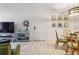 Inviting living area with light wood floors, minimalist decor, and comfortable seating near dining area at 3269 Beneva Rd # 103, Sarasota, FL 34232