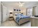 Relaxing bedroom with a ceiling fan, stylish decor, and ample natural light from the window at 3269 Beneva Rd # 103, Sarasota, FL 34232