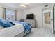 Bright bedroom with a neutral color scheme, window views, and a view to the hallway and front door at 3269 Beneva Rd # 103, Sarasota, FL 34232