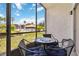 Cozy screened patio with comfortable seating and lovely views of the manicured lawn and community pool at 3269 Beneva Rd # 103, Sarasota, FL 34232