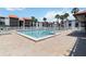 Inviting swimming pool surrounded by stylish condo buildings and comfortable lounge chairs for residents to enjoy at 3269 Beneva Rd # 103, Sarasota, FL 34232