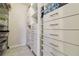Organized walk-in closet with custom shelving and drawer systems for ample storage space at 3269 Beneva Rd # 103, Sarasota, FL 34232