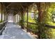 Charming walkway with wooden beams, climbing vines, and lush greenery providing a scenic and shaded path at 3269 Beneva Rd # 103, Sarasota, FL 34232