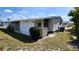 Backside view of a home with white siding and an enclosed screened in porch at 3308 Oakwood S Blvd, Sarasota, FL 34237
