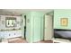 Bathroom area featuring vanity with sink, toilet and closet in a light green paneled room at 3308 Oakwood S Blvd, Sarasota, FL 34237