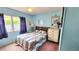 Bedroom with floral bedding, wood headboard, window with curtains, and dresser at 3308 Oakwood S Blvd, Sarasota, FL 34237