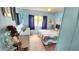 Blue bedroom featuring a bed with floral pattern bedding, dresser and carpeted floors at 3308 Oakwood S Blvd, Sarasota, FL 34237