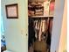 Open closet with clothes hanging on the bar and items stored on the upper shelf at 3308 Oakwood S Blvd, Sarasota, FL 34237