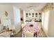 Cozy dining room featuring a floral tablecloth, built-in cabinets, and decorative accents at 3308 Oakwood S Blvd, Sarasota, FL 34237