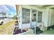 Charming front porch with steps, decorative plants, and welcoming decor in a well-maintained exterior at 3308 Oakwood S Blvd, Sarasota, FL 34237