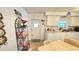 Compact kitchen featuring essential appliances, white cabinets, and a cozy dining area at 3308 Oakwood S Blvd, Sarasota, FL 34237