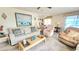 Comfortable living room with sofa, recliner, accent pillows, and a bright airy feel in neutral tones at 3308 Oakwood S Blvd, Sarasota, FL 34237