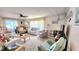 Spacious living room featuring ample seating, ceiling fan, and natural light from sliding glass doors at 3308 Oakwood S Blvd, Sarasota, FL 34237