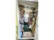 Storage room with washing machine, shelves, cleaning supplies, and ample space for storage at 3308 Oakwood S Blvd, Sarasota, FL 34237