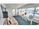 Bright sunroom featuring large windows, floral sofa, comfortable seating, and ample natural light at 3308 Oakwood S Blvd, Sarasota, FL 34237