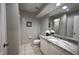This bathroom features a vanity with light countertop and a large mirror, with a nearby toilet at 3803 54Th W Dr # 201, Bradenton, FL 34210