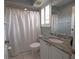 This bathroom is equipped with a vanity with stone countertop, toilet, and shower with curtain at 3803 54Th W Dr # 201, Bradenton, FL 34210