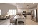 Open kitchen with white cabinetry, stainless steel appliances, and a marble island with bar seating at 3803 54Th W Dr # 201, Bradenton, FL 34210