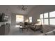 Cozy living room with an open floor plan, neutral decor, and plenty of natural light from shuttered windows at 3803 54Th W Dr # 201, Bradenton, FL 34210