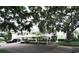 Exterior of building with dedicated covered parking, surrounded by mature landscaping and a manicured lawn at 3803 54Th W Dr # 201, Bradenton, FL 34210