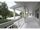 Long covered outdoor walkway with white columns offering shade and showcasing the building's architecture at 3803 54Th W Dr # 201, Bradenton, FL 34210