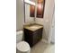 Bathroom with vanity and wood cabinet, granite countertop and tan tile floor at 4037 Crockers Lake Blvd # 14, Sarasota, FL 34238