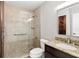 Bright bathroom featuring tiled walk-in shower, granite vanity top, and modern fixtures at 4037 Crockers Lake Blvd # 14, Sarasota, FL 34238
