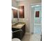Bathroom with granite countertop and wood cabinet, with view to hallway at 4037 Crockers Lake Blvd # 14, Sarasota, FL 34238
