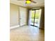 Bright bedroom with neutral walls, tile floors, and sliding glass door to outside at 4037 Crockers Lake Blvd # 14, Sarasota, FL 34238
