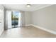Bright, airy bedroom with sliding glass doors to private balcony at 4037 Crockers Lake Blvd # 14, Sarasota, FL 34238