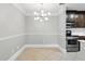 Open dining area featuring modern light fixture and stainless steel appliances at 4037 Crockers Lake Blvd # 14, Sarasota, FL 34238